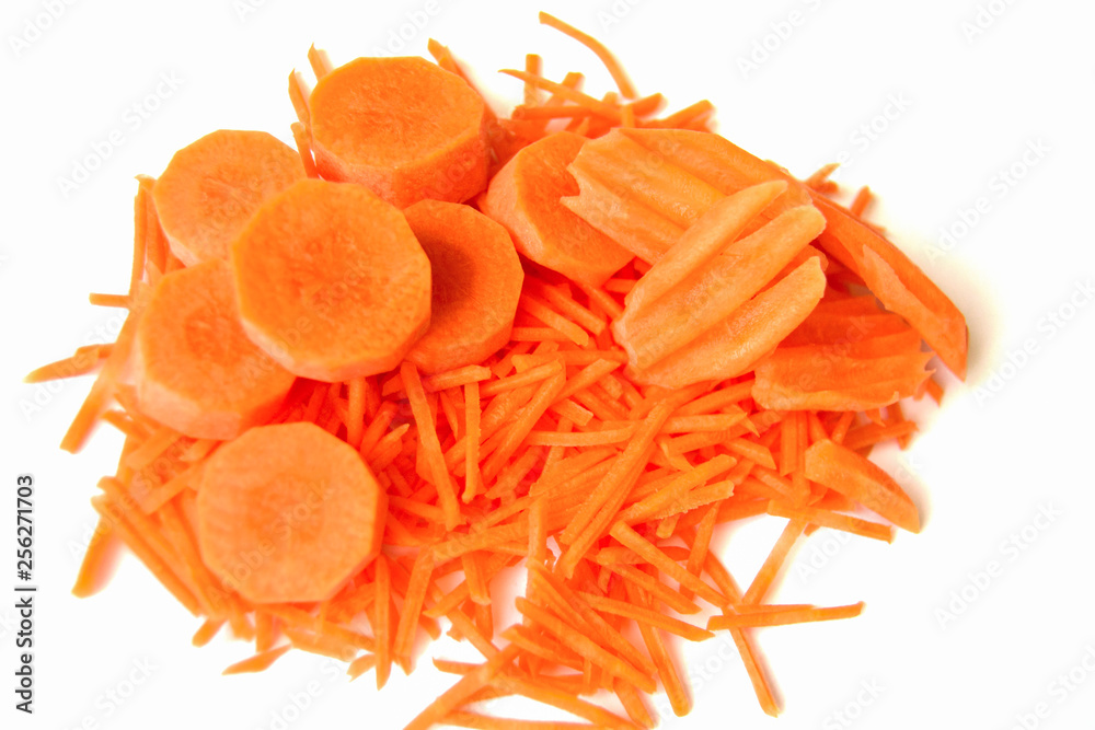 Carrot sliced into slices, straws and a wave on white background Carrot sliced into slices, straws and a wave on white background