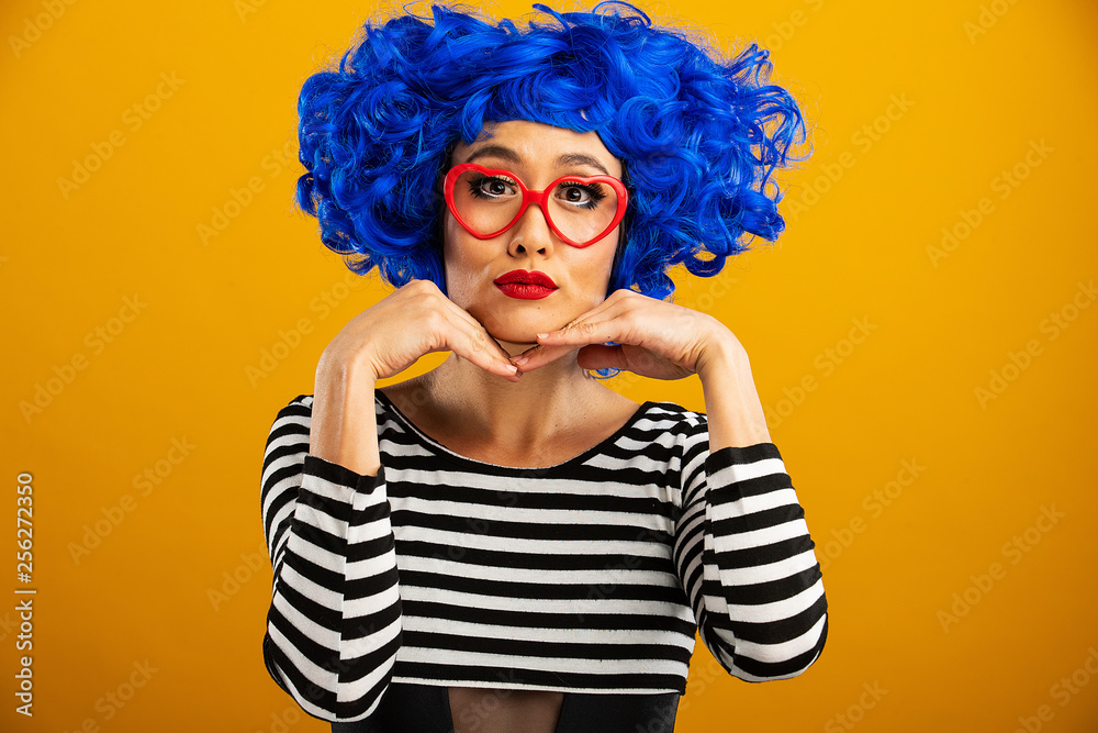 © Mat Hayward - Fun portrait of pretty Asian woman with bright blue wig and red heart shaped glasses