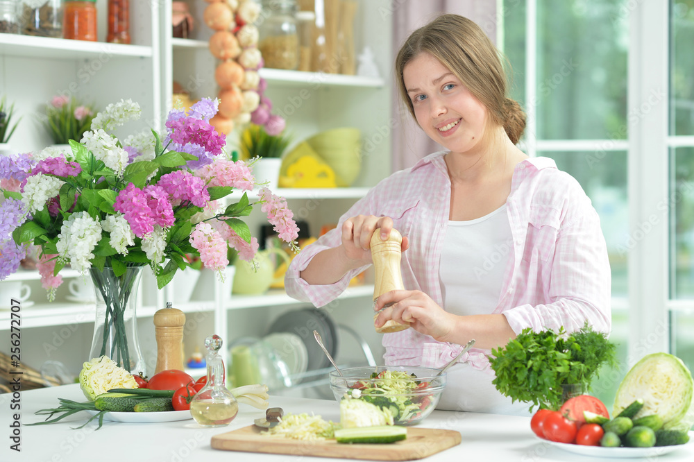Portrait of teen girl preparing fresh salad