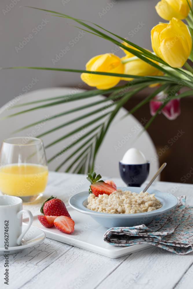 Breakfast oatmeal porridge with fruits berries and coffee cup. Oatmeal with strawberries and banana. Healthy breakfast concept. Breakfast oatmeal porridge with fruits berries and coffee cup. Oatmeal with strawberries and banana. Healthy breakfast concept.