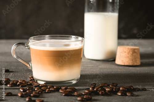 Spiced latte or coffee in a glass on a blue background