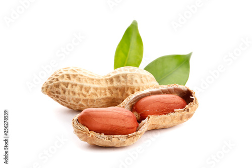 Raw peanuts on white background with green leaf. Healthy snack ona white background.Top view. close-up.
