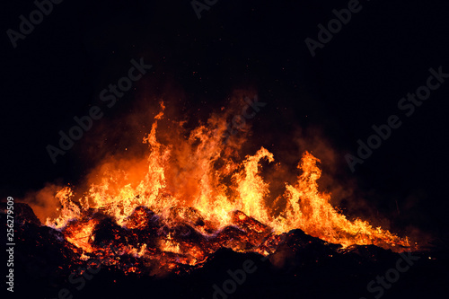 Huge flames from a bonfire at night