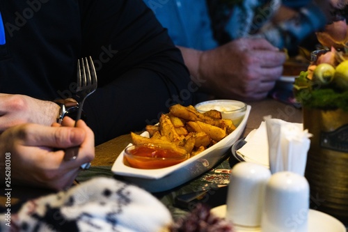 People eating in the restaurant  coffee  potatoes and pizza on the table. Slovakia