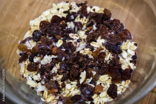 Oat flakes in the bowl with rozins and nuts and plant milk. Slovakia photo