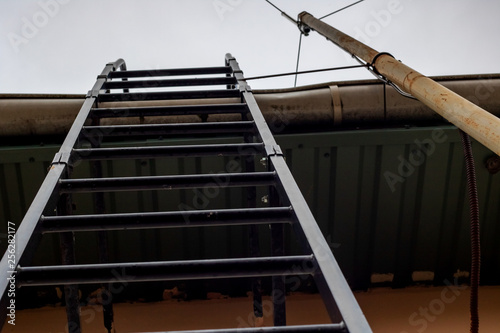 Staircase to the roof close up on sky background photo