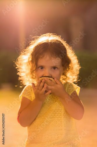 Little girl eating a cupcake