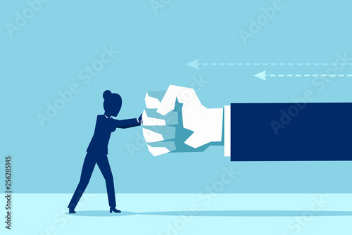 Vector of a woman fighting back a giant fist, protecting herself from work abuse photo