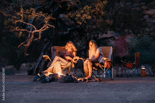 Namibia, friends sitting at campfire playing guitar © Westend61