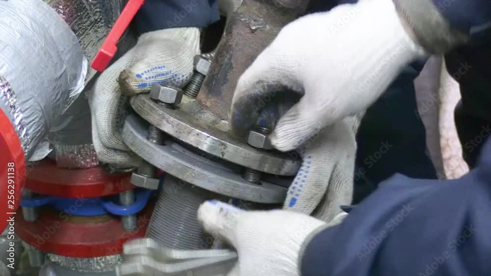 Technicians do water pump repair works. Bolts and nut are locked for