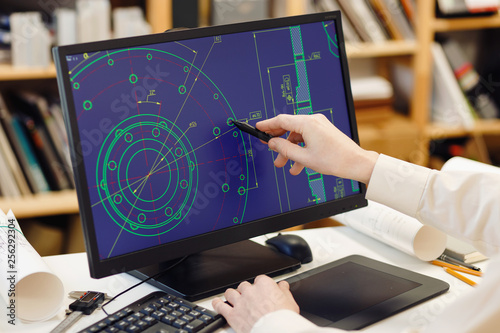 Engineer working on computer at the design of cad scheme.
