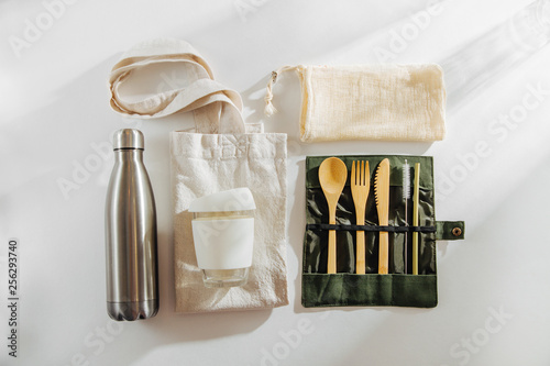 Set of Eco friendly bamboo cutlery, eco bag  reusable coffee mug  and  water bottle. Sustainable lifestyle.  Plastic free concept. photo