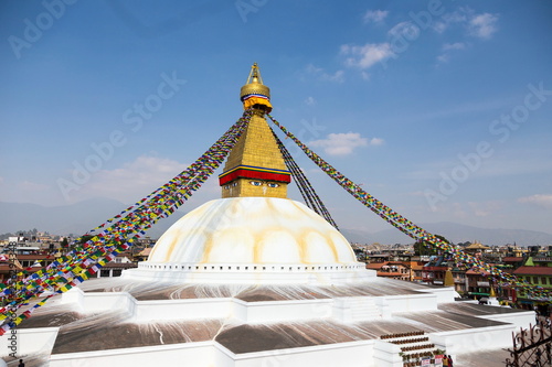 Iconic spherical Buddhist Boudhanath stupa and Kathmandu rooftops seen from a terrace, Kathmandu, Nepal