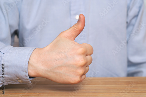 close up of businessman hand showing thumbs up