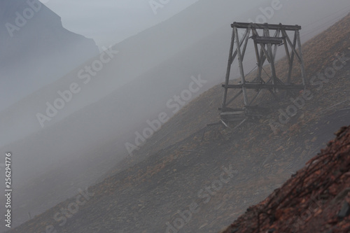 Old coal mine tranportation pillar, misty morning in Longyearbyen, Svalbard, Norway