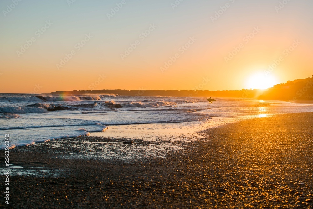 Beautiful sunset on the beach. Sea and surf