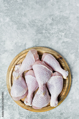 Raw chicken legs. Gray background, top view, space for text.