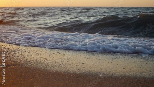 Sea waves at sunset closeup