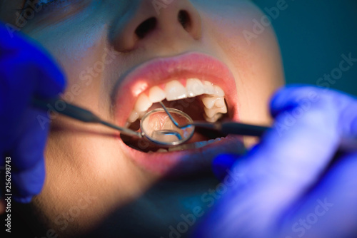 Canvas Print female dentists treating patient