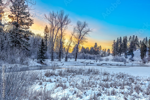 Sunrise on whitefish river, montana in winter on a cold and frigid morning photo