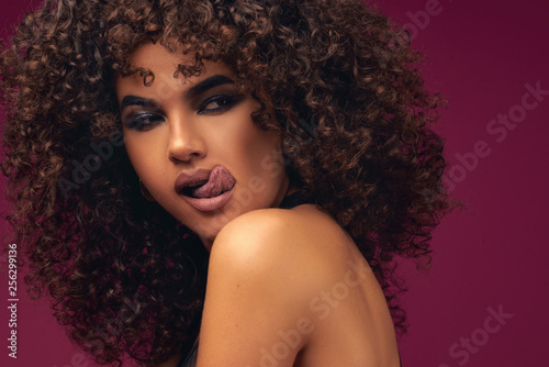 portrait of curly model on bright background