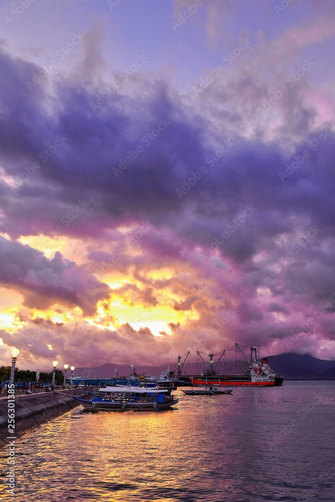 Dramatic skies-sunset over oceangoing cargo and tourist balangay-bangka boats. P.Princesa-Palawan-Philippines-0755