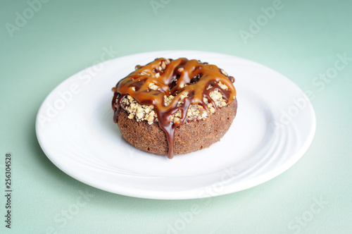 Donut Coated with Chocolate, Caramel and Nuts - Unhealthy Breakfast Eating