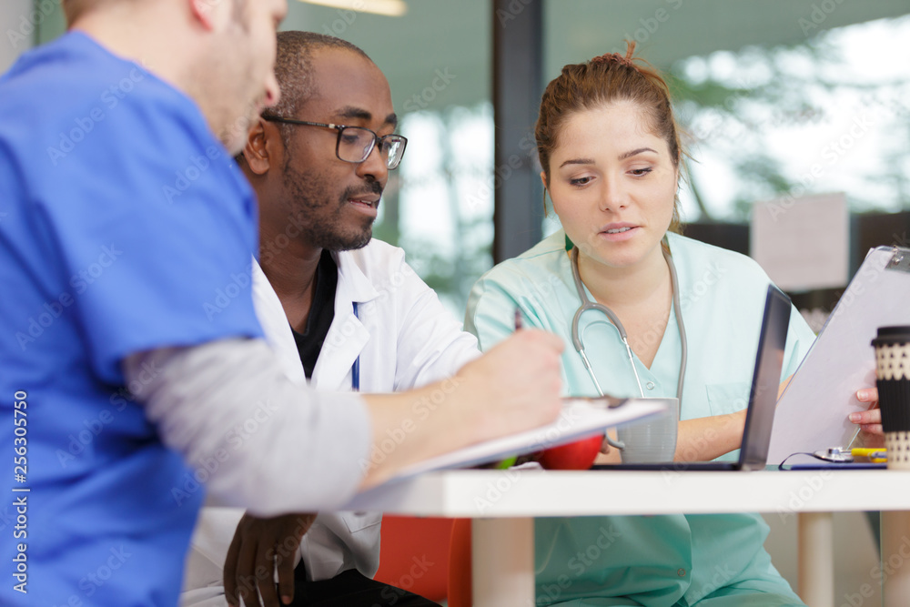 doctors and nurse having informal meeting in hospital canteen doctors and nurse having informal meeting in hospital canteen