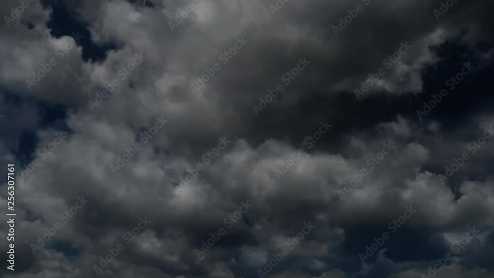 Dark storm clouds building in a time lapse overlay across a moody skycscape Dark storm clouds building in a time lapse overlay across a moody skycscape