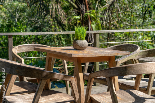 Wooden table and chairs in empty tropical cafe next to rice terraces in island Bali, Indonesia © OlegD