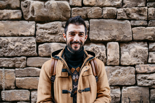 Spain, Igualada, portrait of smiling man at stone wall photo