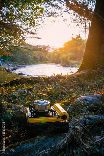 Picnic gas stove and aluminum teapot for boiling water during camping