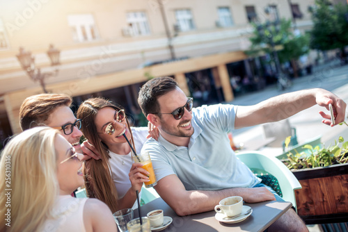 Cheerful group of friends have fun in cafe