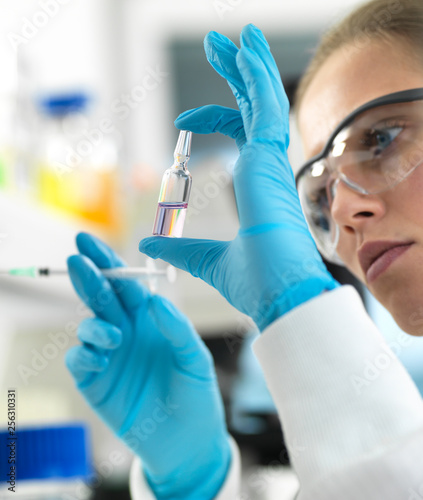 Pharmaceutical Research, Scientist preparing a new drug for testing in the laboratory photo