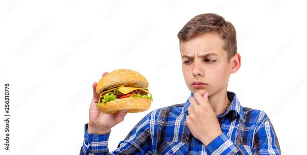 Caucasian boy eating burger and hamburger on white background, beef. Caucasian boy eating burger and hamburger on white background, beef.