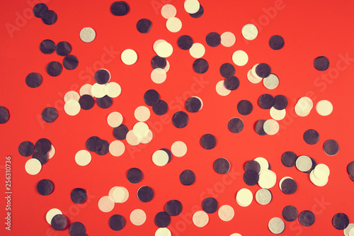 Red background with black and white confetti.