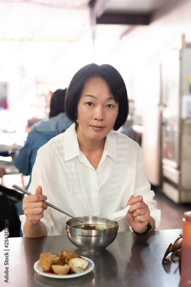 mature Asian woman eat noodles mature Asian woman eat noodles