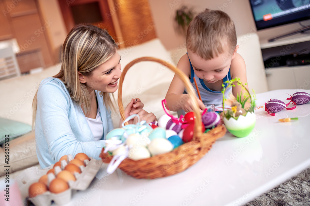 Mother and her son painting colorful Easter eggs Mother and her son painting colorful Easter eggs