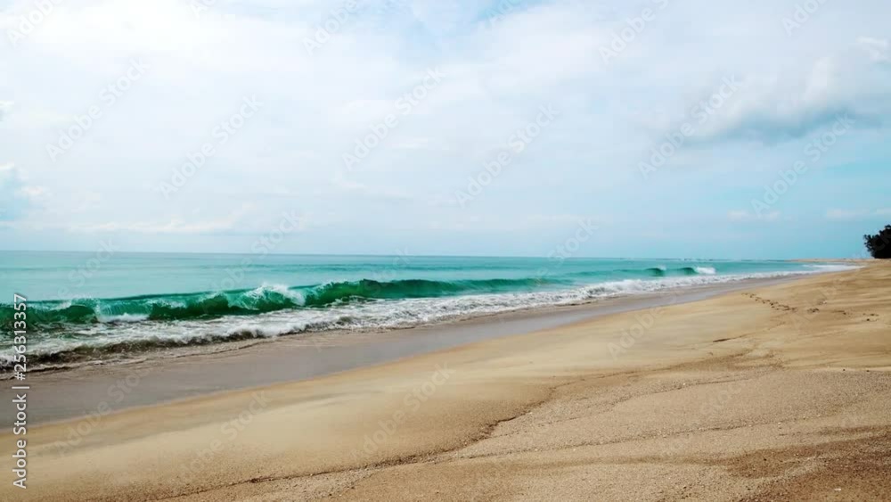Waves hitting the shore. Soft wave of blue sea on sandy beach. Background. Yellow warm sand and summer sea. Wave Of green Ocean Hit Sandy Beach. Sunny Summer Vacation Waves hitting the shore. Soft wave of blue sea on sandy beach. Background. Yellow warm sand and summer sea. Wave Of green Ocean Hit Sandy Beach. Sunny Summer Vacation