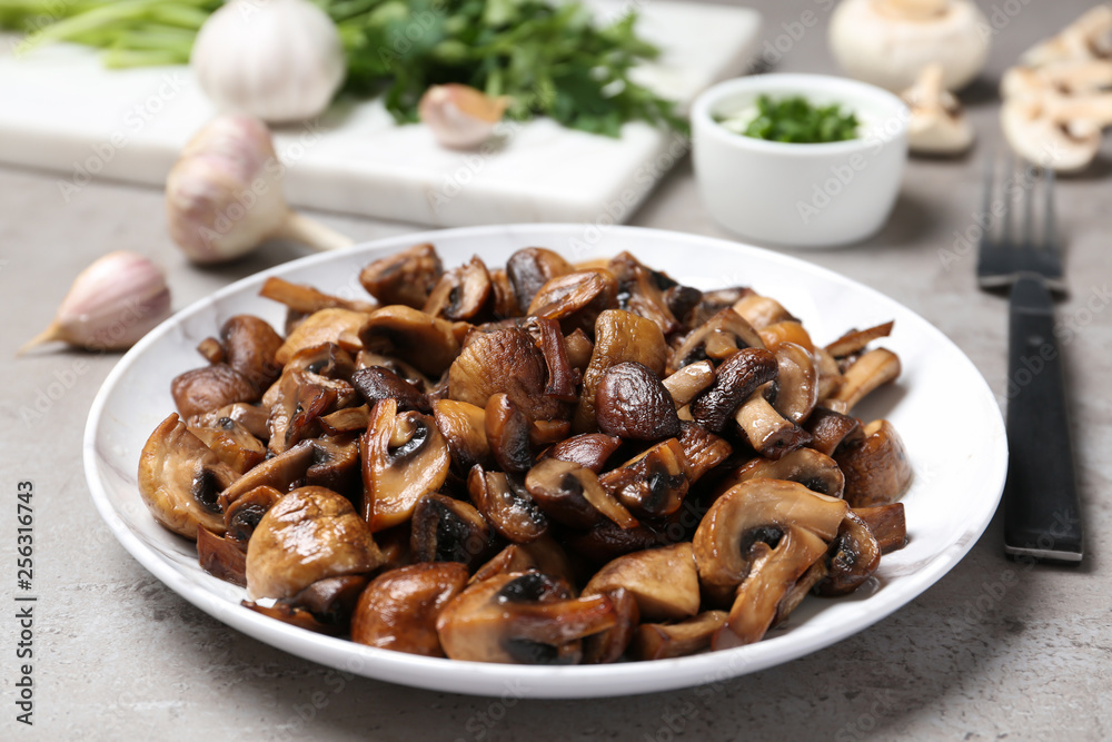 Plate of tasty fried mushrooms on table