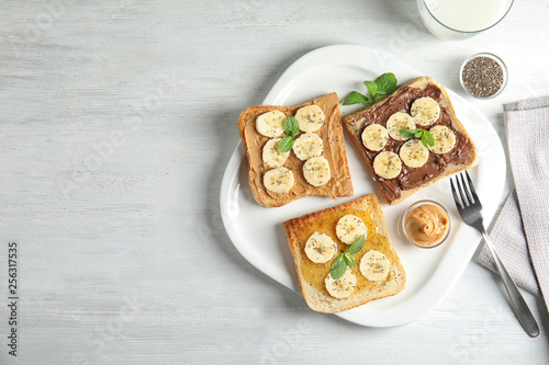 Tasty toasts with banana, mint and chia seeds served on table, top view. Space for text