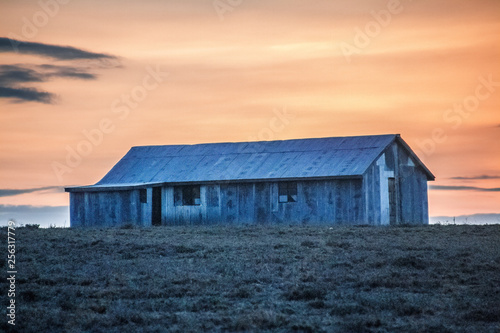 corrugated iron hut at sunset