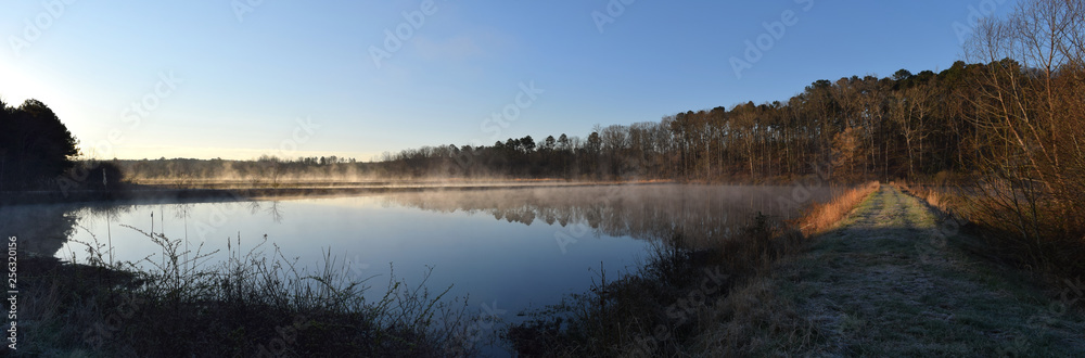 Morning steam fog rises over ponds in Mississippi