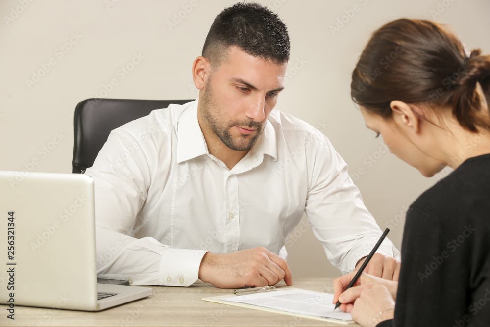 Businessman pointing finger at the document and showing to the customer where to sign a contract Businessman pointing finger at the document and showing to the customer where to sign a contract