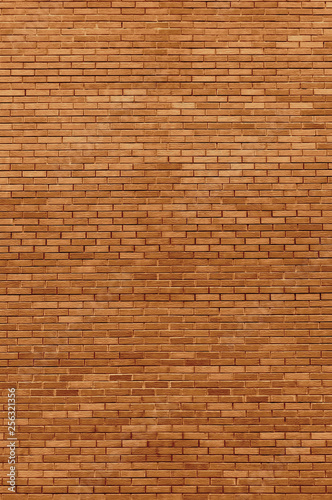 Red beige bricks stone wall decorative background closeup, vertical grunge pattern, old aged weathered texture, natural grungy textured reddish vintage, rough rustic brick birckwork