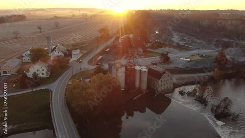 Aerial Flying over the Conestoga River, Bushong's Mill / Zook's Flour Mill and into the autumn sunset Lancaster County, Pennsylvania Concept: autumn, light, the Industrial Revolution photo