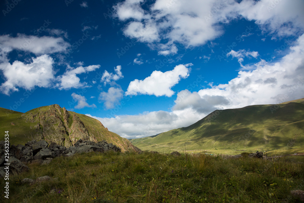 Mountains and the nature of the North Caucasus, the blue sky over high rocks in the beautiful gorge Mountains and the nature of the North Caucasus, the blue sky over high rocks in the beautiful gorge