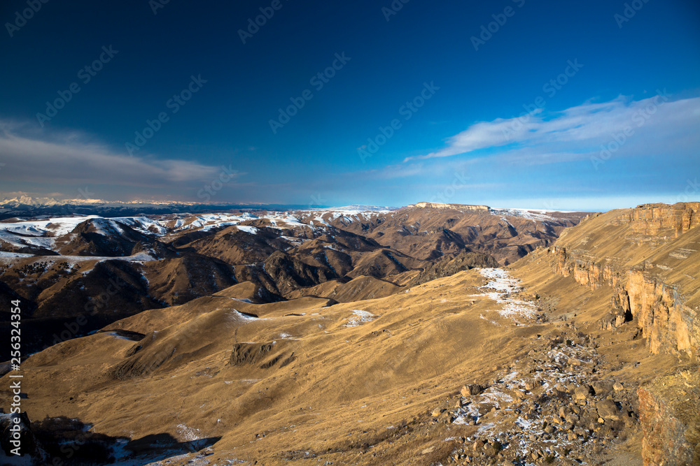 Fototapeta premium Mountains and the nature of the North Caucasus, the blue sky over high rocks in the beautiful gorge
