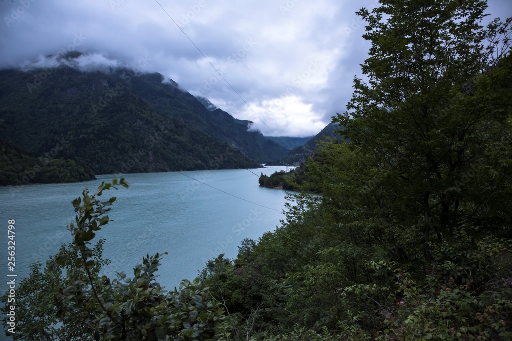 The mountain river in the picturesque gorge, the lake with blue water, the wild nature of the North Caucasus
