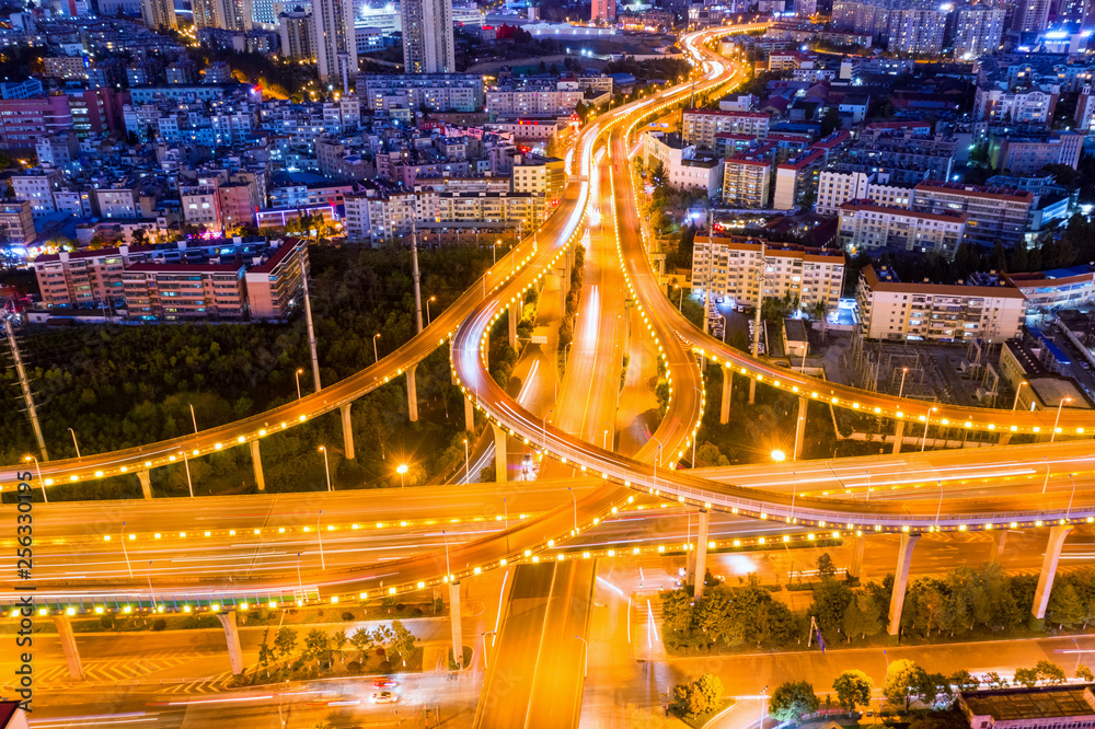 aerial view of overpass and winding road at night